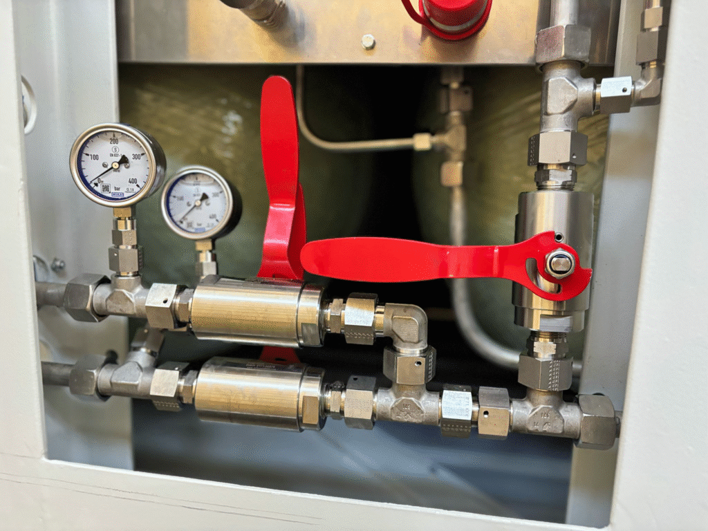 High-pressure gas valve assembly with two pressure gauges and stainless steel fittings for CNG or hydrogen systems.